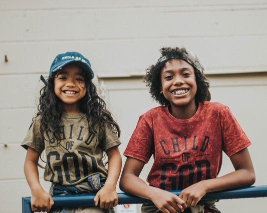 Dezi(right) and Gray(left) smiling in Child of God tee
